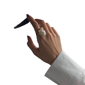 Irregular golden geometric ring with a large baroque pearl for a modern minimalist look