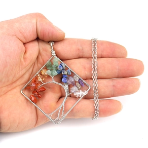 Detail of handmade silver wire wrapped square Tree of Life pendant with 7 chakra stones.
