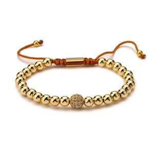 Close-up of golden beaded adjustable bracelet with a sparkling micro-pave zircon ball