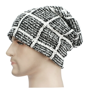 Detail of black and white checkerboard knit beanie showing thick texture and pattern