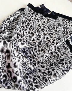 Detailed view of folded satin scarf featuring black and white animal leopard print texture