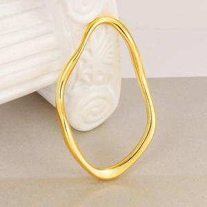 Minimalist 304 stainless steel gold irregular wavy bangle on a white pedestal base
