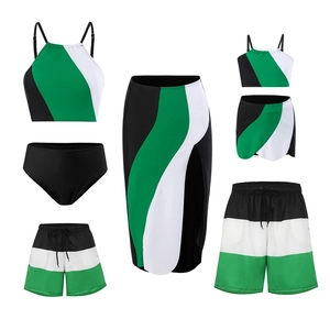 Matching family swimwear set in green, white and black color block style with beach cover-up