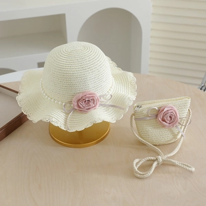 Close-up of girl's straw hat and bag set with pink roses and pearl bead accents