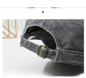 Detail view of adjustable metal buckle on dark grey washed cotton flat top army cap