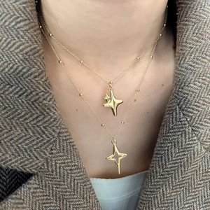 Double-layered gold stainless steel necklace featuring two polished star pendants