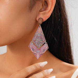 Ethnic geometric diamond-shaped wooden earrings with tribal print shown on model