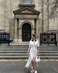 Detailed shot of white knit dress with contrast black lapel and button-down front