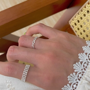 Close-up of minimalist adjustable 925 silver plated chain ring on a finger