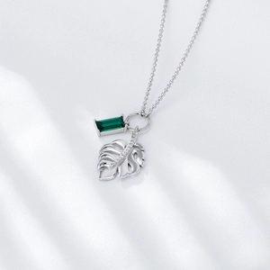 925 silver necklace featuring green emerald zircon and monstera leaf pendant on white silk