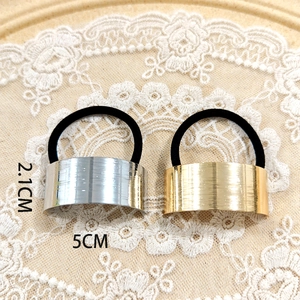 Detail showing gold and silver hair ties with 5cm wide brushed metal plates and dimensions