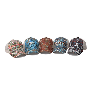 Five assorted mesh ponytail baseball hats with floral, leopard and cow prints on white