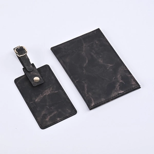 Close-up of marble texture PU leather passport holder and luggage tag travel set