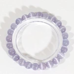 Detail of lavender cat eye stone beads with unique optical chatoyancy and elastic cord