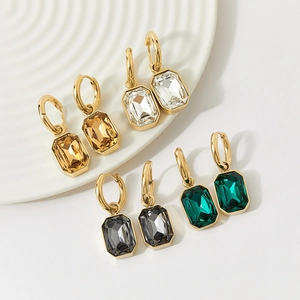 Vintage sugar cube crystal drop earrings in four colors on a white ceramic plate