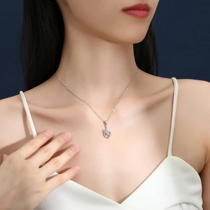 S925 sterling silver heart necklace with moissanite stone on a model's collarbone