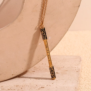 Detail of Ruyi Jingu Bang pendant with engraved Chinese characters and cloud pattern
