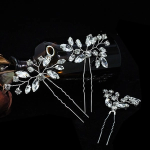 Detail of silver handcrafted wedding hair combs with sparkling rhinestones set of three