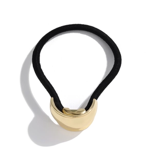 Minimalist black elastic hair tie featuring a polished gold half-moon metal crescent clip