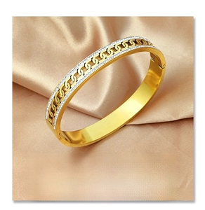Detail of 18K rose gold titanium bangle featuring interlocking links and pave crystal inlay