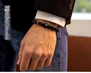 Men's black obsidian beaded bracelet with gold letter B charm worn with a business suit