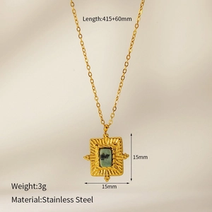 Detail of gold stainless steel necklace featuring a square green natural stone pendant