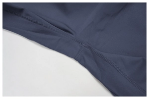 Detailed close-up of navy blue yoga jumpsuit showing reinforced flatlock stitching
