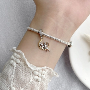S925 sterling silver snake chain bracelet featuring a gold moon and fairy charm with crystals