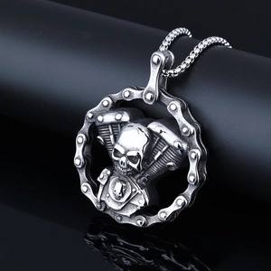 Vintage stainless steel skull necklace with engine detail on a matte black display