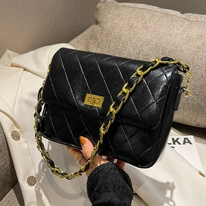 Retro black quilted crossbody bag with gold chain strap and square metal lock closure