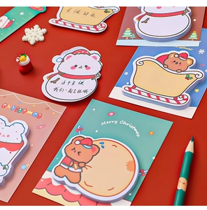 Detailed close-up of cartoon Christmas sticky notes with Santa and snowman on red background