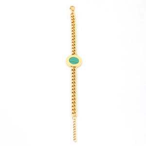 Detail of a gold-plated bracelet featuring a green round stone inlay and adjustable chain