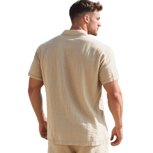 Rear view detail of casual beige linen short sleeve shirt showing relaxed fit and texture