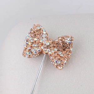 Macro shot of champagne crystal bow pendant with sparkling rhinestones for DIY jewelry