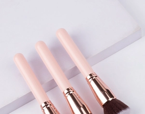 Close-up of pink foundation and powder brushes with gradient synthetic bristles
