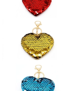 Close-up of heart-shaped sequin keychains in red, gold, and blue with lobster clasps
