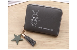 Detail of grey PU leather coin purse featuring a rabbit print and star charm tassel