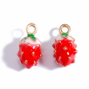 Detail of red strawberry fruit alloy charms with gold loops for DIY jewelry making