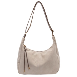 Detail of beige suede hobo bag featuring dark brown leather strap and decorative fringe