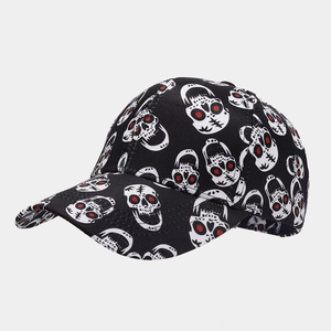 Detail of baseball cap featuring all-over skull print and red eye accents on black fabric