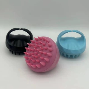 Set of three silicone scalp massage brushes in pink, black, and light blue with soft bristles