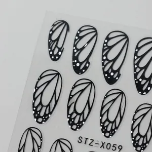 Macro detail of black butterfly wing nail stickers with intricate hollow patterns