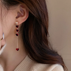 Vintage asymmetric gold heart chain earrings with red textured pattern and crystals