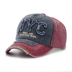 Macro shot of NYC embroidery and wavy stitching on vintage washed baseball cap