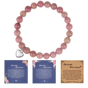 Close-up of pink natural stone bracelet with heart charm and three inspirational gift cards