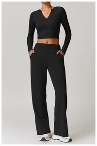 Detail showing high-waisted wide-leg yoga pants with side pockets in black athleisure style