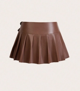 Detail of high-waist pleated brown PU leather mini skirt showing texture and wide folds