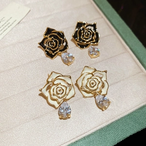 Detail of 18k gold-plated enamel flower earrings with water drop zircon in a jewelry box