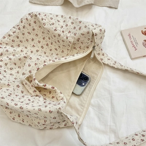 Macro view of floral canvas bag interior with a pocket for smartphone storage