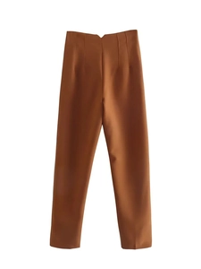 Detailed view of high-waist caramel brown dress pants with slim fit tailoring